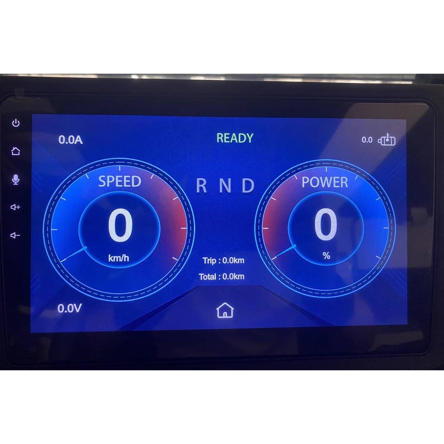ocean cartz close-up view of a digital dashboard display screen in an electric golf cart or NEV. The blue-themed touchscreen panel shows the vehicle is "READY" and displays twin circular gauges for "SPEED" (reading 0 km/h) and "POWER" (reading 0%). The screen also shows the gear selector ("R N D"), battery status ("0.0V"), current draw ("0.0A"), trip distance ("0.0km"), and total mileage ("0.0km"), highlighting the modern instrumentation of the electric vehicle.