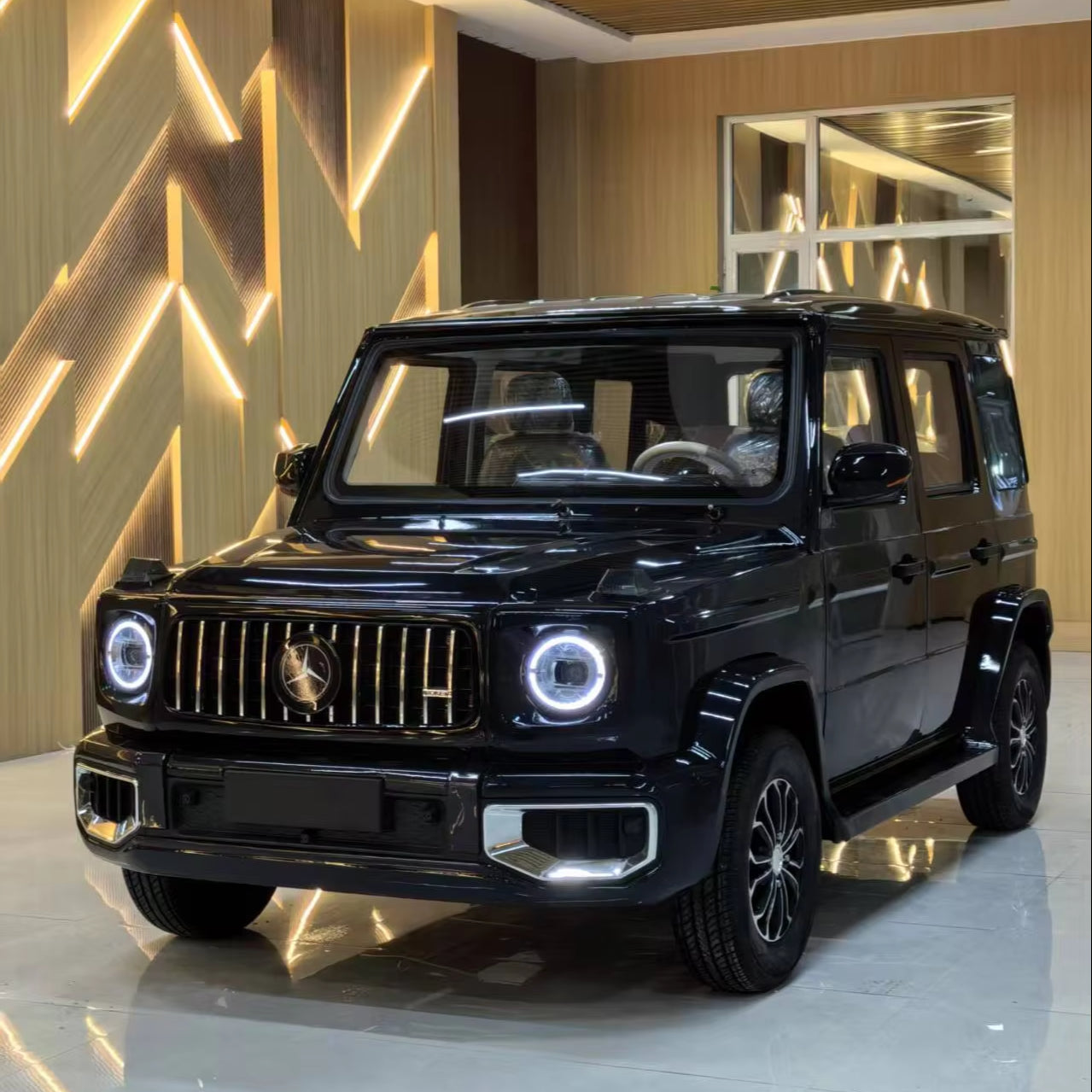 Black Mercedes-Benz SUV in a showroom with decorative wall and floor.