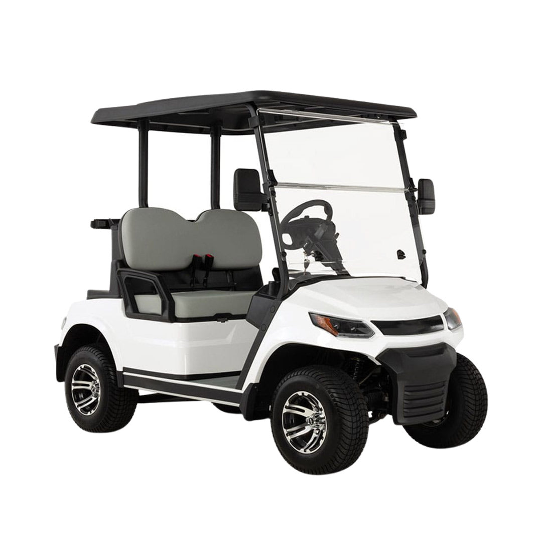 ocean cartz three-quarter front studio shot of a white four-seater golf cart with a black roof and a modern front design, set against a pure white background. This electric vehicle features light gray seats, a full windshield, and black fender flares. The golf cart is equipped with all-terrain tires and custom black and chrome wheels, highlighting its contemporary style and practicality.