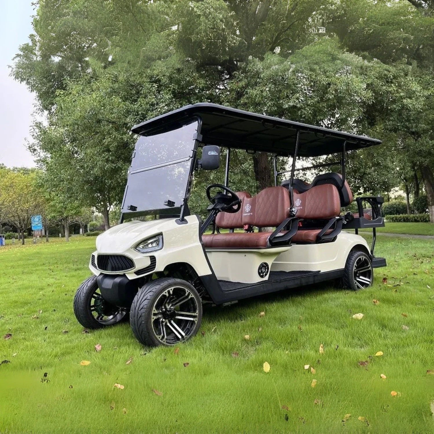 Golf cart on a grassy area with trees in the background