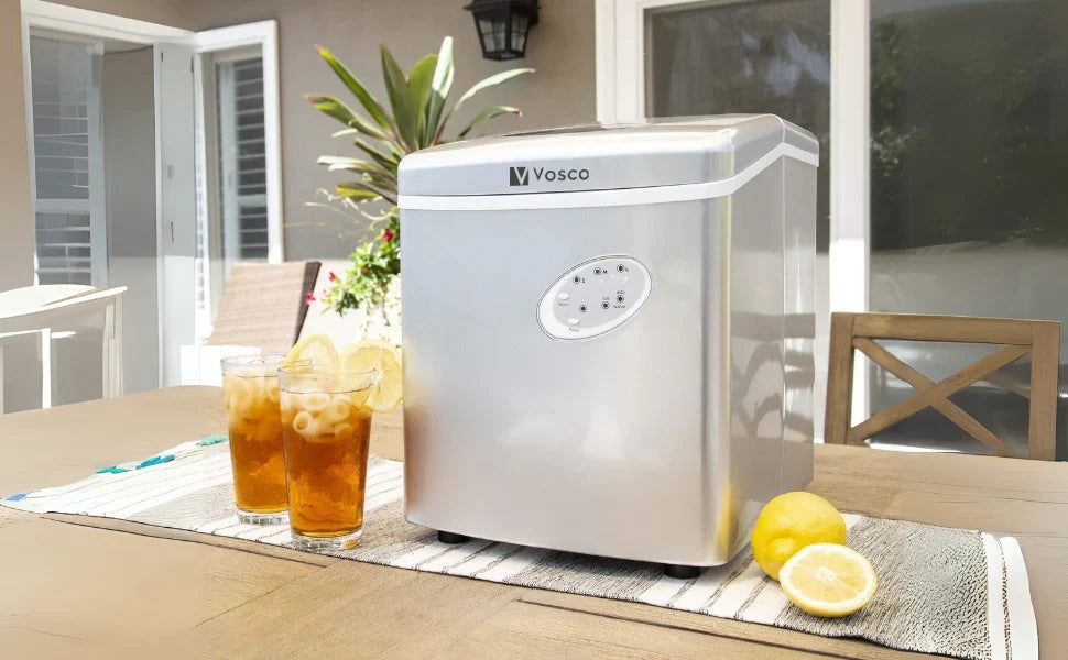 Vosco portable ice maker on a table with iced tea and lemons outdoors