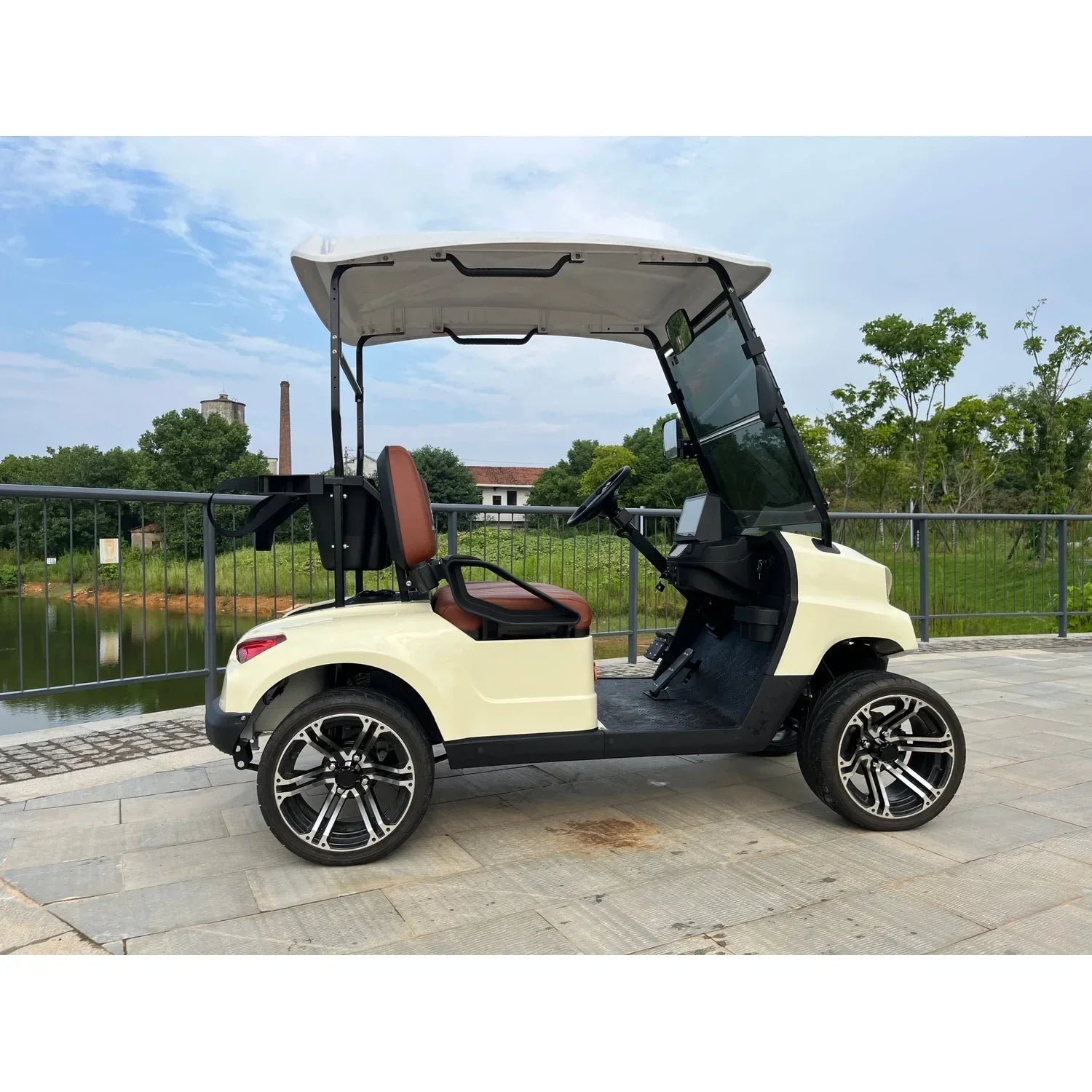 Side profile showing cream body, brown seats, and 12-inch alloy wheels.