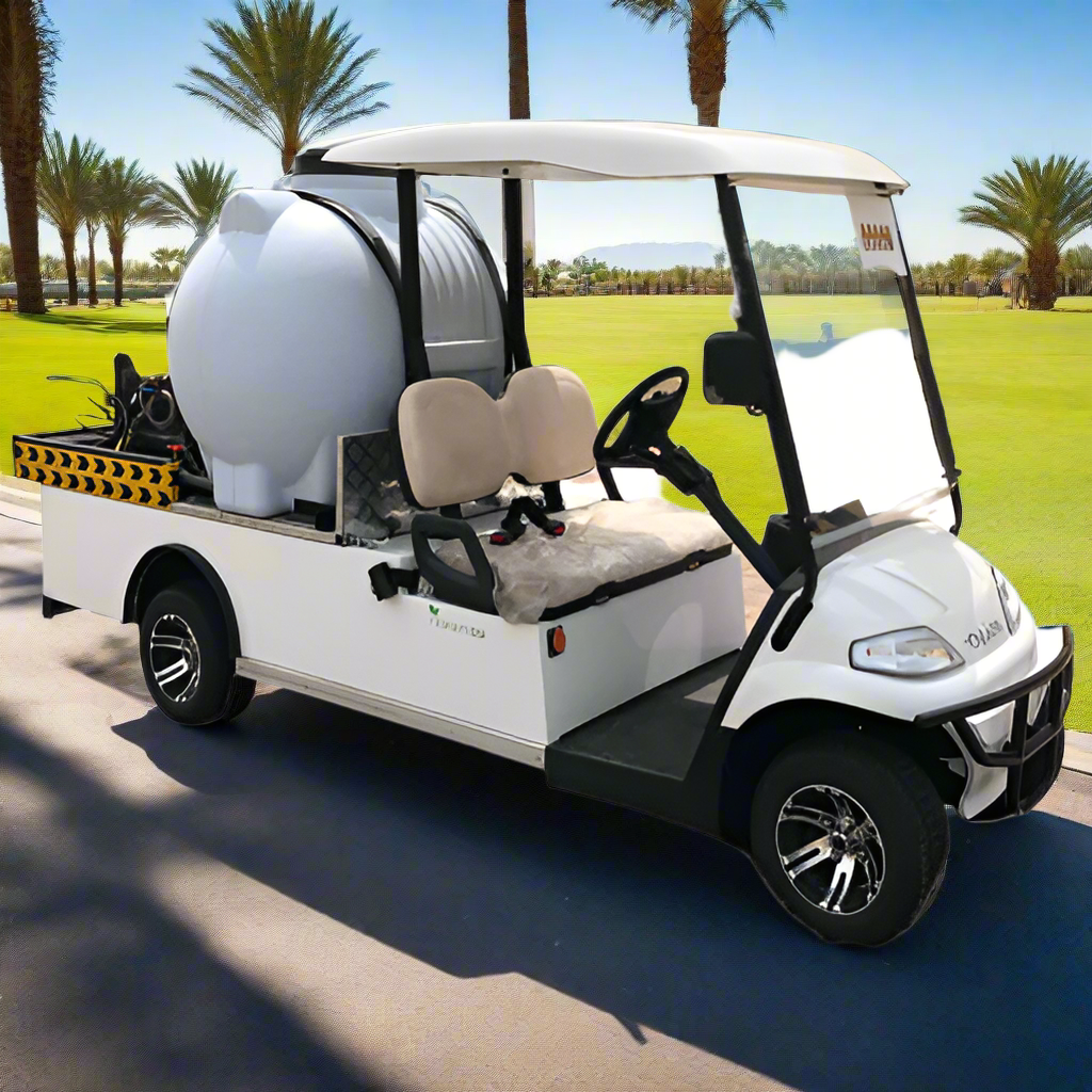 A white electric utility golf cart with a large water tank and integrated pressure washer parked on a paved path.