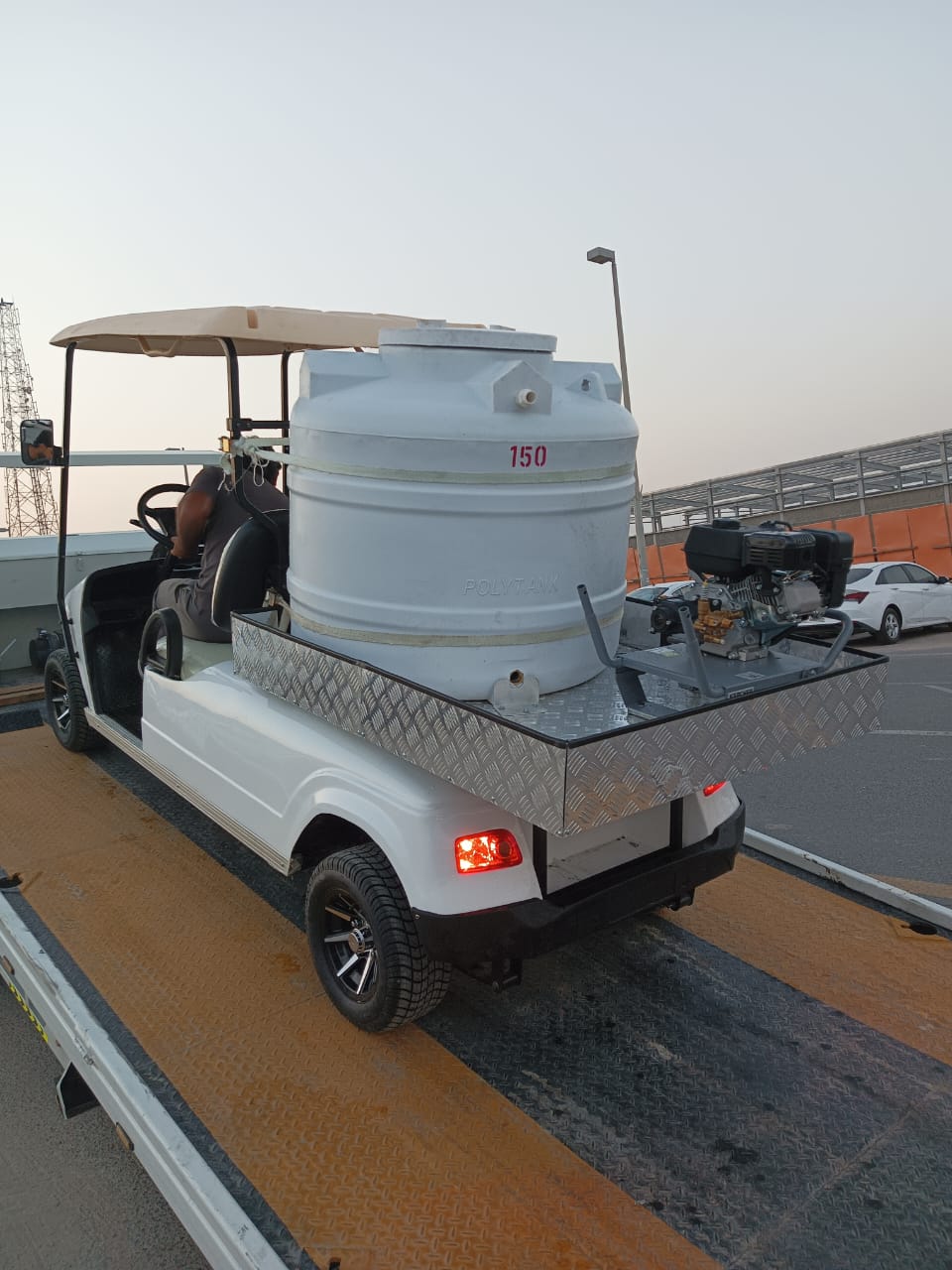 A white electric utility golf cart with a 150L water tank and pressure washer.