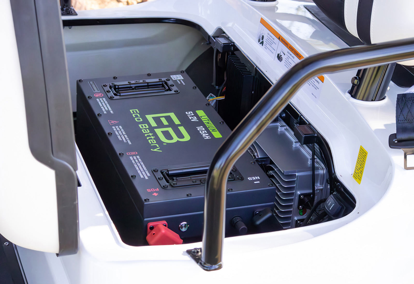 Battery pack labeled 'EB' inside a piece of machinery, likely a construction vehicle.