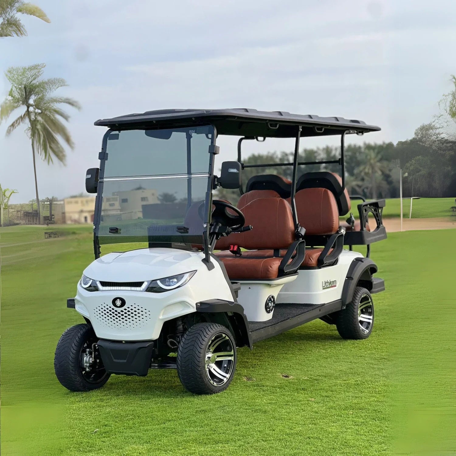 White golf cart with brown seats on a grassy field