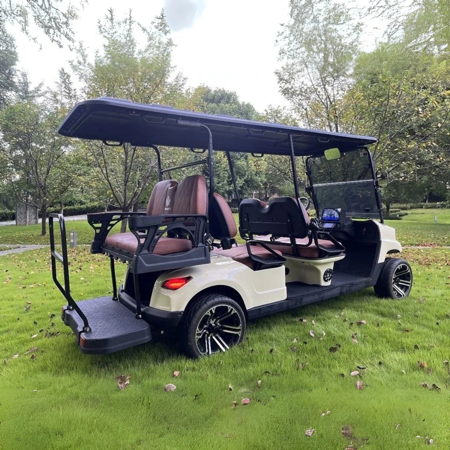 Golf cart on a grassy area with trees in the background