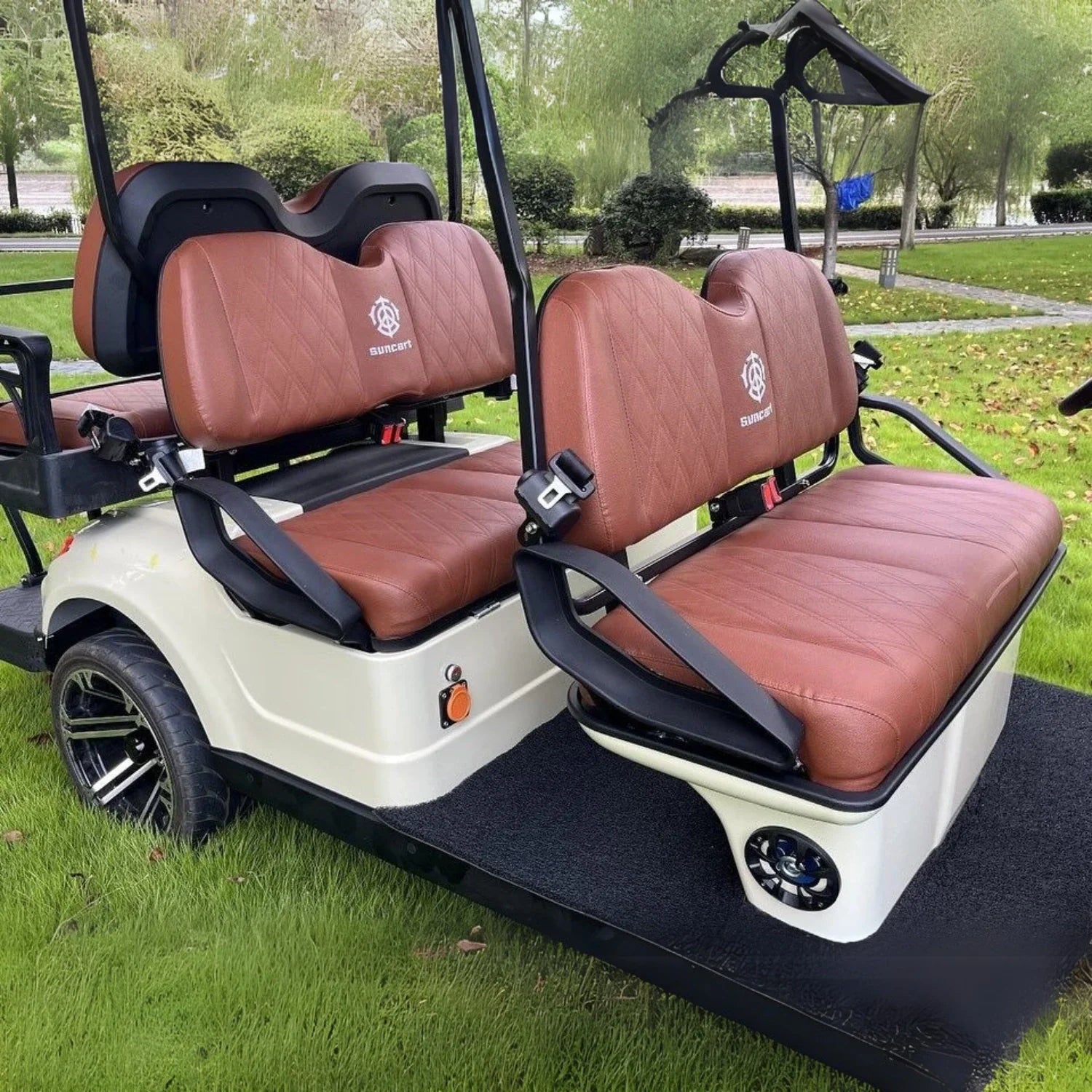 Golf cart with brown seats on a grassy area