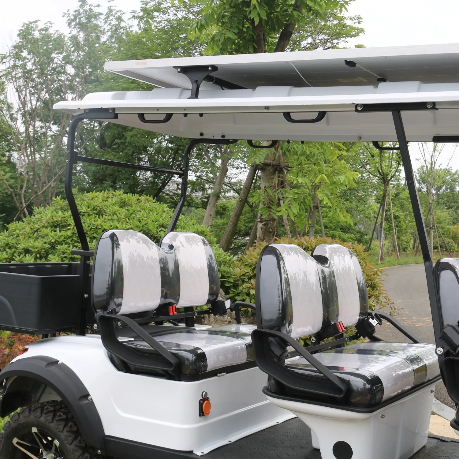 White golf cart with four seats in a park setting
